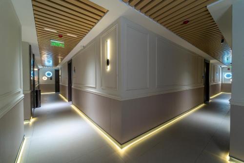 a hallway of a building with lights on the walls at Hill Top Hotel in Aqaba