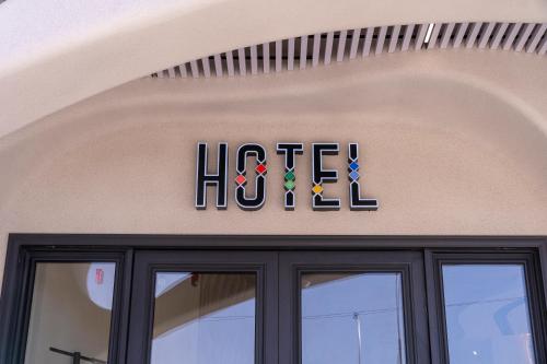 a sign on the front of a building with the word hezbollah at Hill Top Hotel in Aqaba