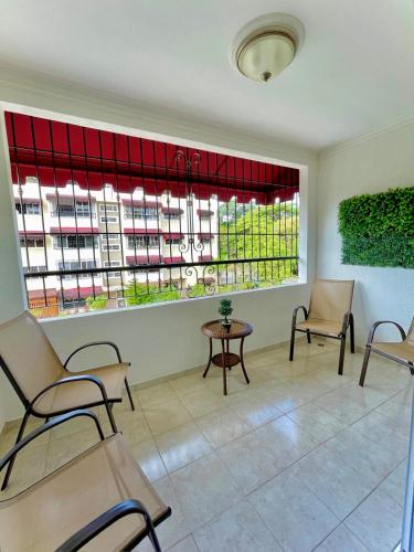 a waiting room with chairs and a large window at FreshBreeze - Apartment Near US Embassy in Santo Domingo