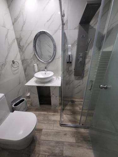 a bathroom with a toilet and a sink and a mirror at Diamond Piraeus Port in Piraeus