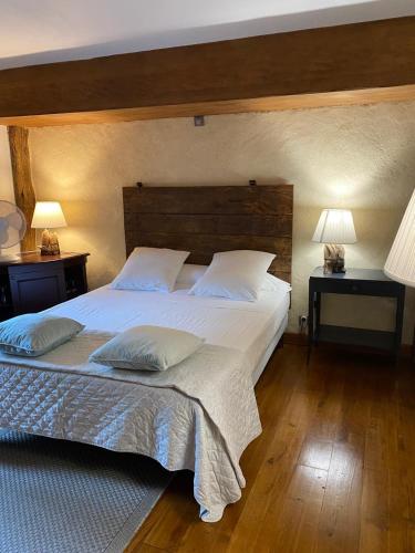 une chambre avec un grand lit blanc avec deux lampes dans l'établissement Ameztoia XVe siècle chambres d'hôtes Navarraises, à Saint-Étienne-de-Baïgorry