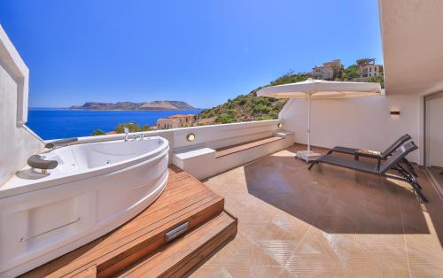 a bath tub in a room with a view of the ocean at Molino Hotel in Kas