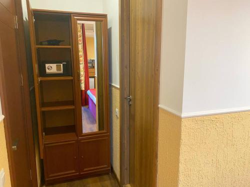 an empty room with a door and a room with a mirror at Hotel Orange Kutaisi in Kutaisi