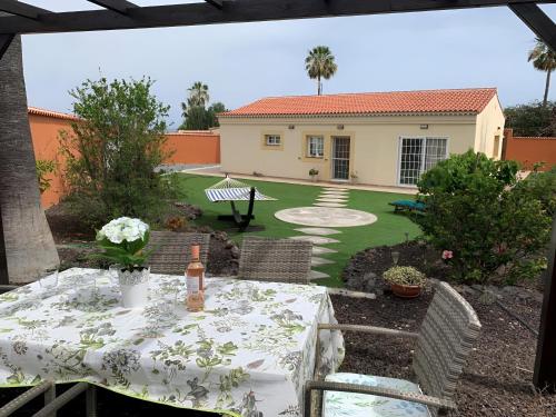 a patio with a table and a house at Villa Chloé in San Miguel de Abona
