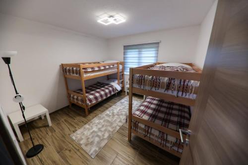 a room with two bunk beds and a lamp at Holiday Residence Šehić in Visoko