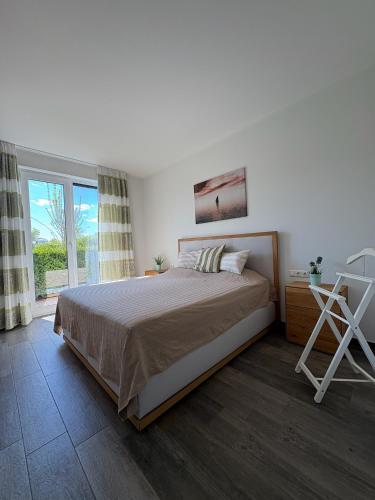 a bedroom with a large bed and a window at Brisare in Göhren-Lebbin