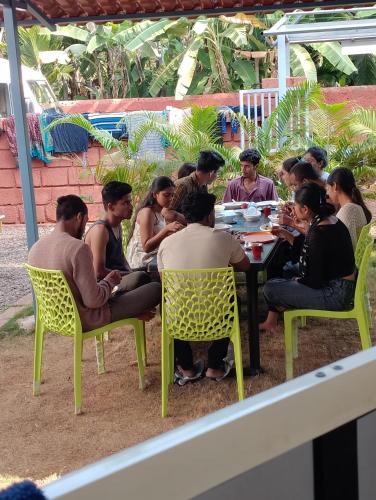 a group of people are sitting around a table at Wantara resort in Diveagar