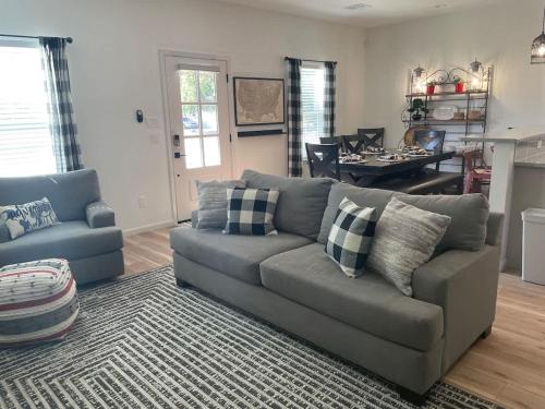 a living room with a couch and a table at TAYLOR PLACE-5 Minutes to Silos & Baylor in Waco