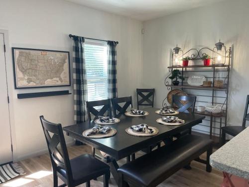 a dining room with a black table and chairs at TAYLOR PLACE-5 Minutes to Silos & Baylor in Waco