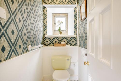a bathroom with a toilet and a window at Plas Gwynfryn in Llanbedr