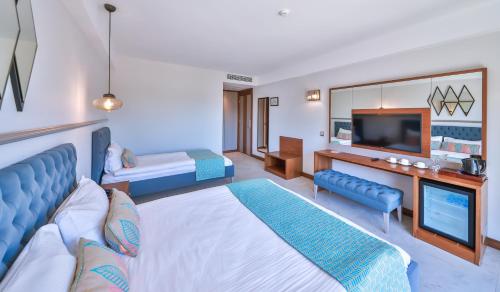 a hotel room with a bed and a tv at Molino Hotel in Kas