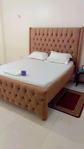 蒙巴萨Arsan Homes 1 bedroom Kisimani Heights的卧室内的一张大床,带软垫床头板