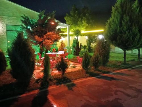 a garden at night with a table and trees at Green Land in Tbilisi City