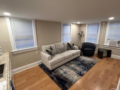 a living room with a couch and a chair at Cute and Cozy Apt Near Historic Downtown Sanford in Sanford