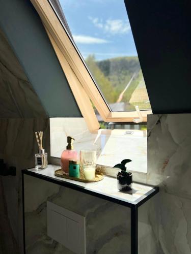 a table in a room with a window at Mon Amor Chalet in Şirnea