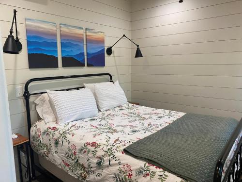 a bedroom with a bed with a floral bedspread at Incredible Mountain Views with Private Hot Tub! in Highlands