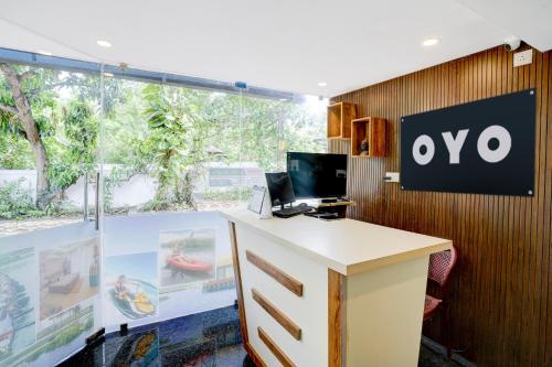 an office with a desk with a sign on the wall at Hotel O Alleppey Inn in Alleppey