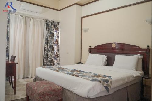 a bedroom with a large bed in a room at AIFU Hotel El Montazah Alexandria in Alexandria