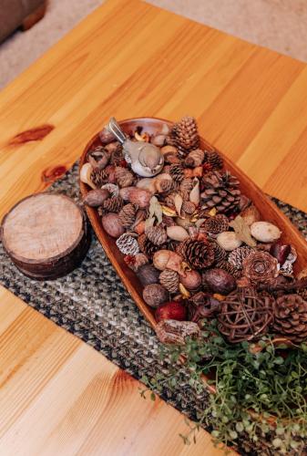 a tray of nuts and mushrooms on a wooden table at Sojourner's Lodge & Log Cabin Suites in Dundee