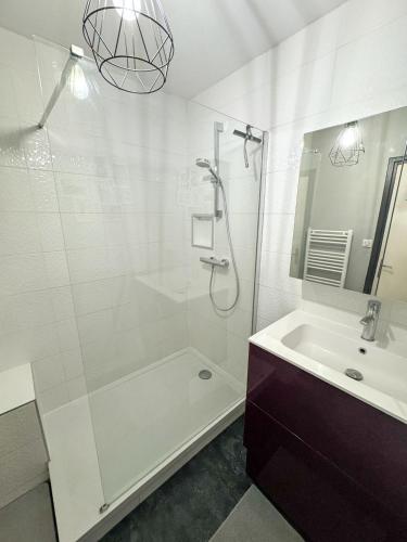 a white bathroom with a shower and a sink at T3 parking and balcony eurexpo in Bron