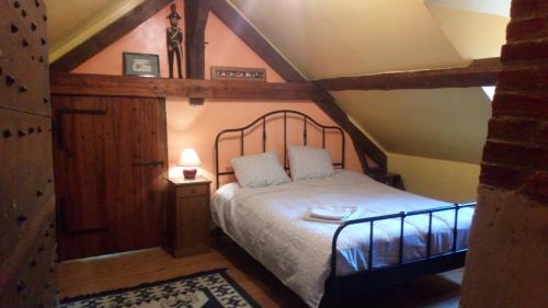 a bedroom with a large bed in a attic at Ancienne maison de famille in Roberval