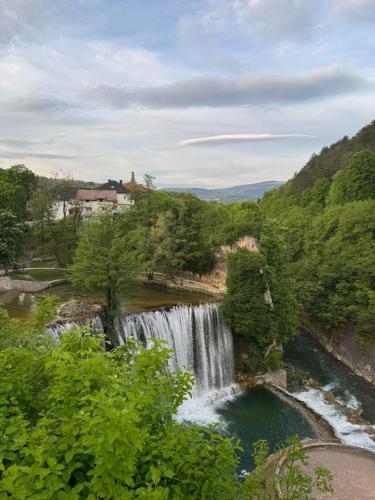 a waterfall in the middle of a river at Freedom in Forest in Jajce