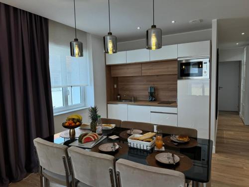 a kitchen with a dining room table with chairs and a tableablish at Hélios Plage in Berck-sur-Mer
