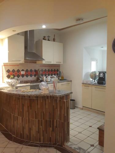 a kitchen with a island in the middle of a room at Studio with Panoramic View in Kairouan