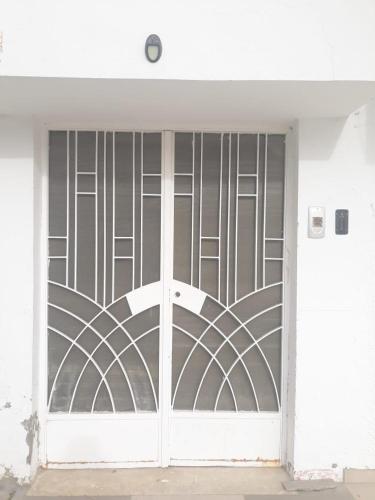 a white door with a gate with a design on it at Studio with Panoramic View in Kairouan