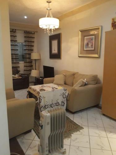 a living room with a couch and a table in it at Studio with Panoramic View in Kairouan
