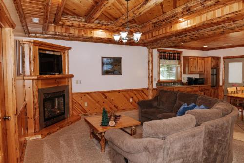a living room with a couch and a fireplace at Sojourner's Lodge & Log Cabin Suites in Dundee