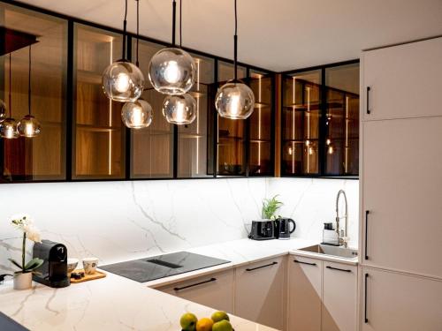 a kitchen with white counters and wooden cabinets at Flussblick am Töpferberg 4 in Bad Schwartau