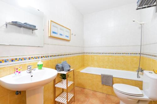 a bathroom with a sink and a toilet and a tub at YOKOI La Antilla in La Antilla