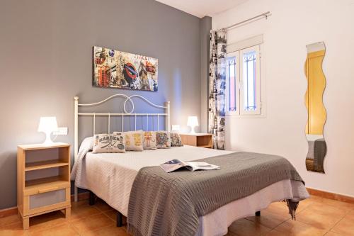 a bedroom with a bed and a painting on the wall at YOKOI La Antilla in La Antilla
