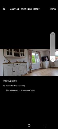 a picture of a living room with a window at Бащината Къща in Sapareva Banya