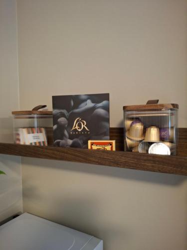 a shelf with a picture and other items on it at Kattugglans Guestroom 1 in Ljungby