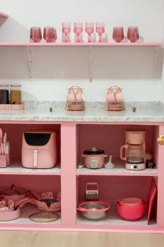 a pink cabinet filled with lots of pink kitchen items at Pink Nashville Cottage - Girls' Trip, 12 Min to Broadway in Nashville
