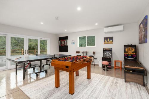 a living room with a ping pong table and a video game at Rivertop Hideaway with HUGE views-Hot Tub-EV-more! in Ahwahnee