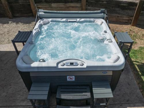 a jacuzzi tub sitting in a yard at Rivertop Hideaway with HUGE views-Hot Tub-EV-more! in Ahwahnee