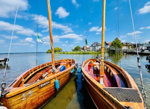 two wooden boats are docked in the water at Lütte Wulke 8, wo Träume Weite finden in Wunstorf