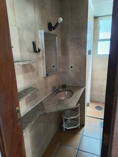 un bagno con lavandino e specchio di Apartamento para temporada em Cabo Frio a Cabo Frio