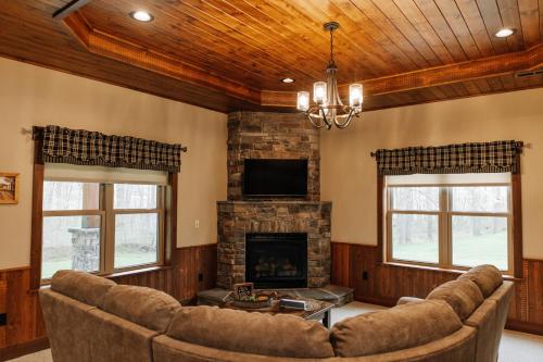 a living room with a couch and a fireplace at Sojourner's Lodge & Log Cabin Suites in Dundee