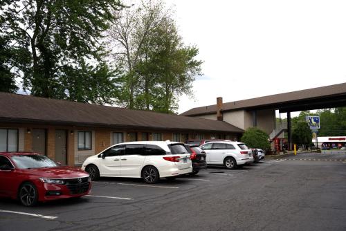 a group of cars parked in a parking lot at Carrier Motor Lodge in Newington