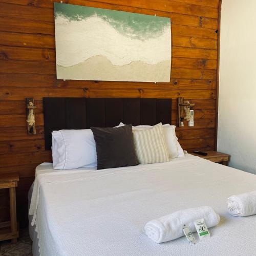 a bedroom with a bed with two towels on it at Encanto Paraty Beach in Paraty