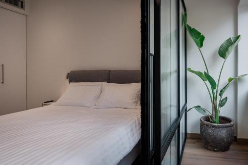 a bedroom with a bed and a potted plant at Olivia Flat 1 in Kalamata