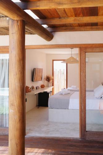 Postel nebo postele na pokoji v ubytování Vila Jangada Xandó Caraíva