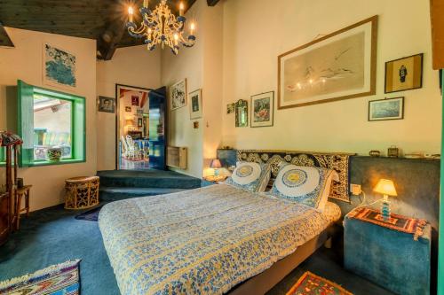 une chambre avec un lit et un lustre dans l'établissement Domaine de la Marguerite, à Lentigny