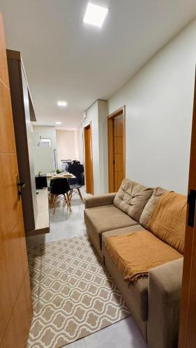 a living room with a couch and a table at Apartamento aconchegante completo -Próximo ao Aeroporto-COP30 in Belém