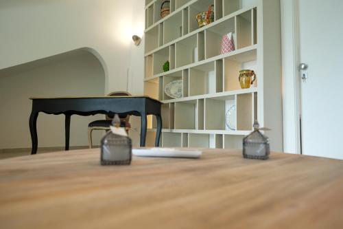 a cat is standing in front of a table at Praialonga Suites with Pool and Garden in Le Castella