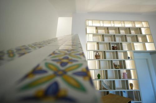 a room with a book shelf and a table at Praialonga Suites with Pool and Garden in Le Castella